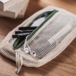 Example of organic cotton tidy bag in use, containing a selection of pencils and ear phones.