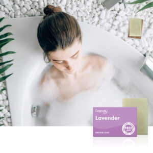 woman relaxing in bathtub with lavender soap