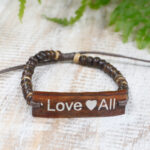 Product Image of Friendship Bracelet featuring the slogan "Love All" with a small heart