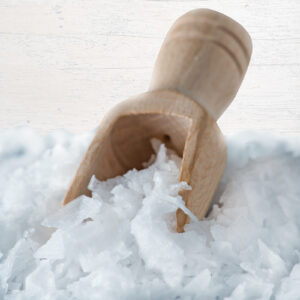 Magnesium flakes with small wooden scoop