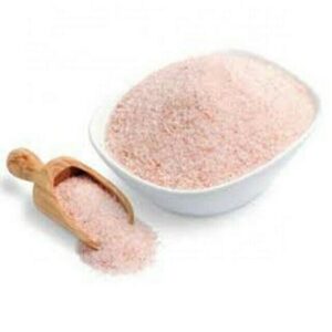 White bowl containing pink himalayan salt with small wooden scoop beside bowl.