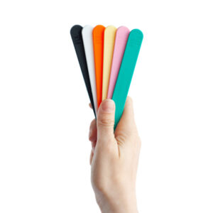 Hand holding a selection of colours of Fix It Sticks