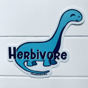 Vegan vinyl sticker of a friendly faced brontosaur in grey with "Herbivore" wording on front sticker displayed on white wooden background