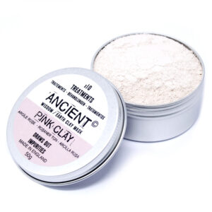 Image of pink clay loose in tin with lid next to the opened tin