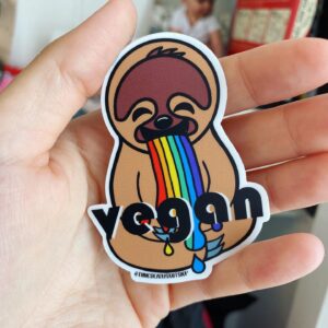 Rainbow sloth sticker in palm of a hand