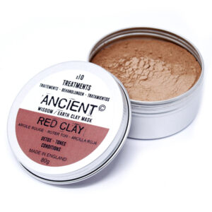 Tin of red clay open with lid beside