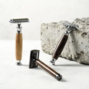 Image of 3 different bamboo handled razors with a concrete block in background