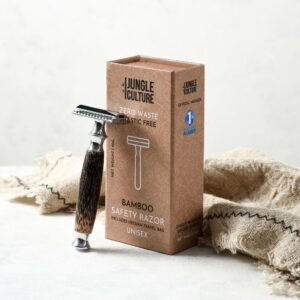 Dark bamboo thick handled safety razor leaning against the packaging box with storage pouch bag beside it