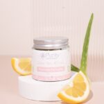 Glass jar with metal screw top lid and plantable label displayed next to a sliced lemon and aloe leaf - Purity Natural Beauty Clear Skin Cream (30ml)