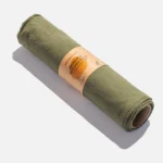 Green cotton reusable kitchen towels on a cardboard roll with a small brown paper label around the middle.