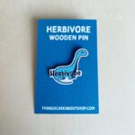 Wooden pin with a dinosaur image.