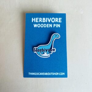 Wooden pin with a dinosaur image.