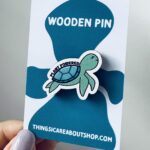 Sea Turtle Plant Powered Wooden Pin. Blue content looking sea turtle design