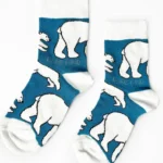 Two socks with white ribs, toes and heels, pale blue with white polar bears all over.