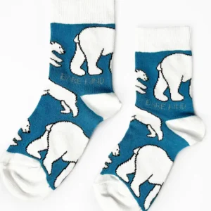 Two socks with white ribs, toes and heels, pale blue with white polar bears all over.