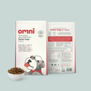 Two paper bags of Vet Formulated plant-based food for Senior Dogs showing the front and back design, with a small white bowl of the complete food kibble in front of one of the bags.
