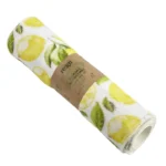 Roll of reusable kitchen towel with lemons printed on white organic cotton with brown paper wrap around the middle
